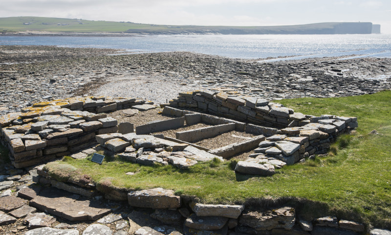 The remains of stone building foundations looking out to sea at the Brough of Birsay.