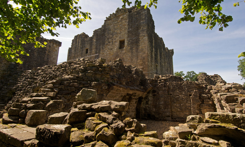 Ruinous building footings and the exceptional residential tower at Craignethan Castle.
