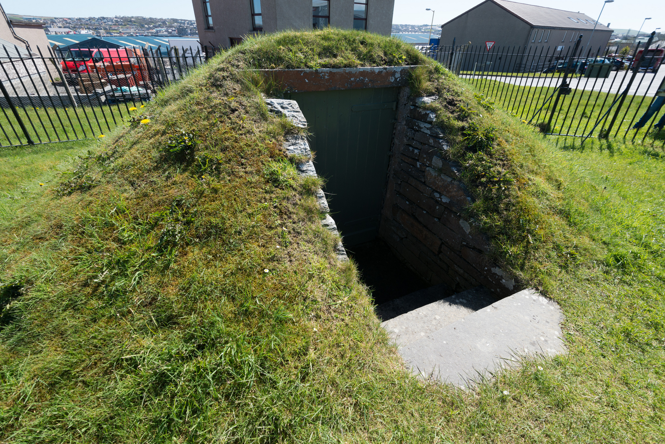 A grassy mound with a stepped entrance down into the chamber