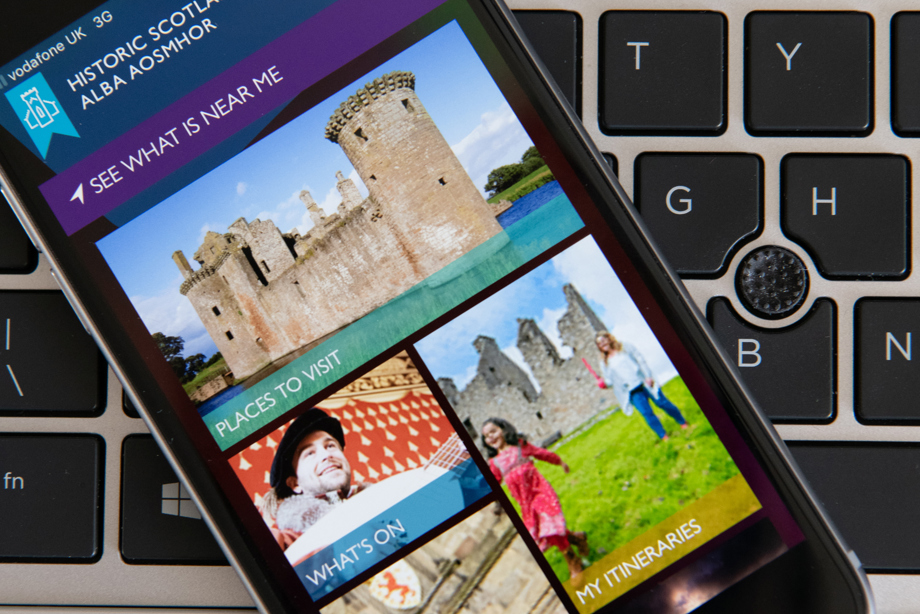 A smart phone displaying Historic Scotland website pages is sitting on top of a laptop keyboard.