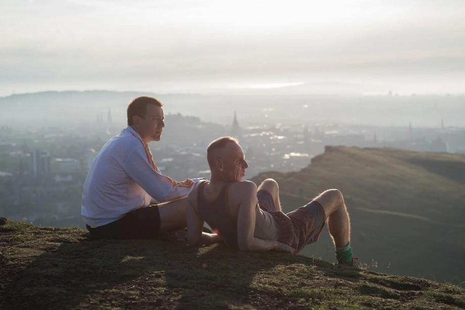 Actors playing Renton and Spud enjoying a view of the city of Edinburgh in the film Trainspotting 2