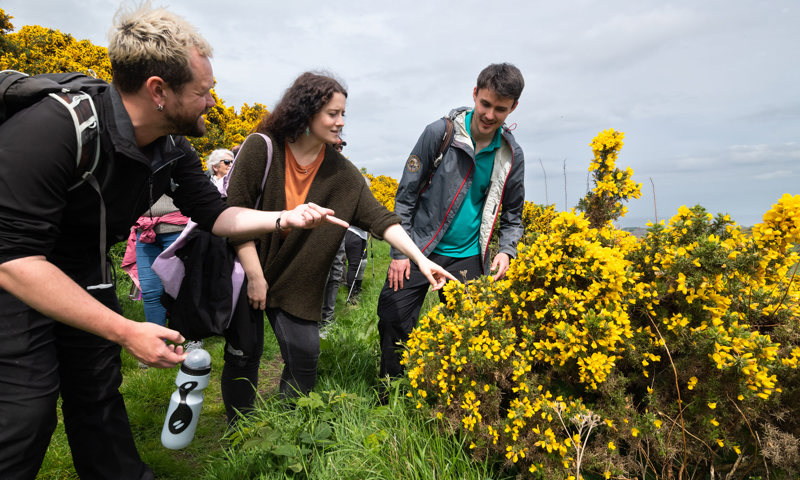 A Ranger talking to visitors on a tour of Holyrood Park