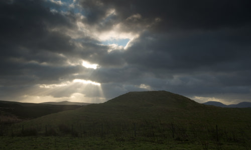 The mound that forms Knowes O’ Trotty chambered cairn at dusk.