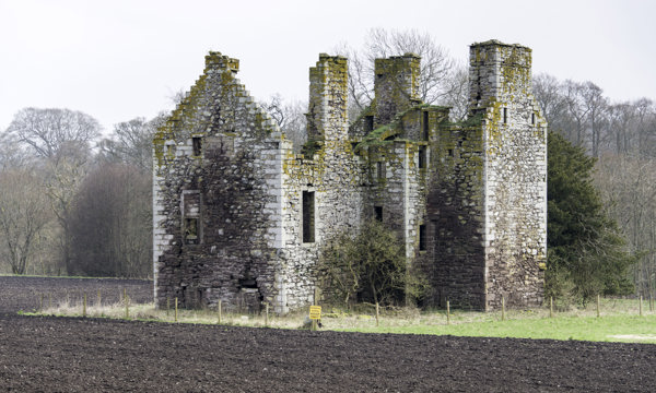 The remains of Innerpeffray Castle, on the edge of some farmland.