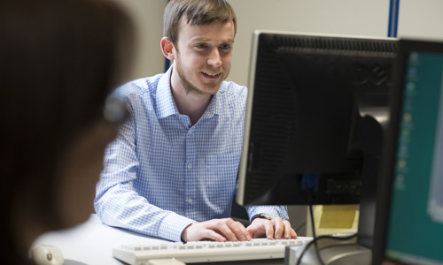 A member of our staff working at a PC.