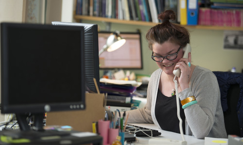 A staff member talking on a telephone.