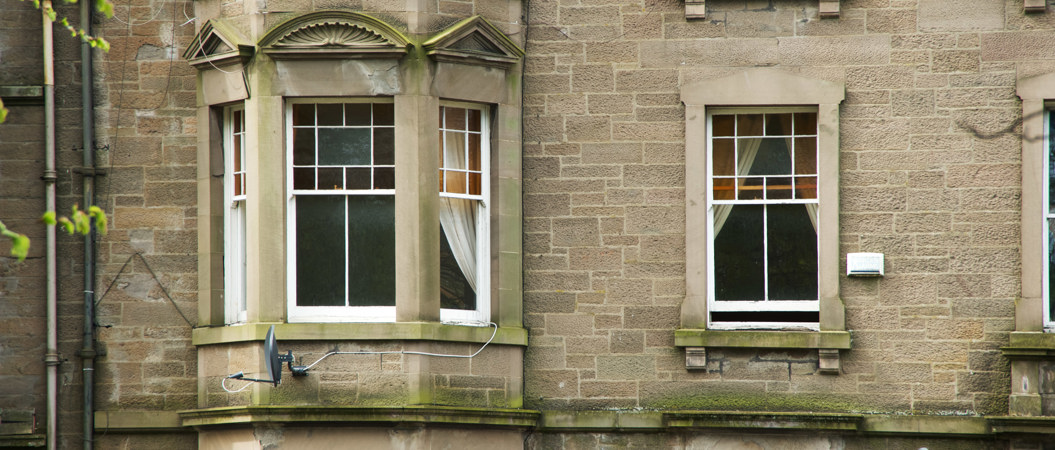 Sash and case windows in some traditional tenements in Dundee.