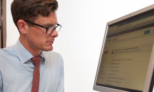 A member of staff, hard at work at a computer.