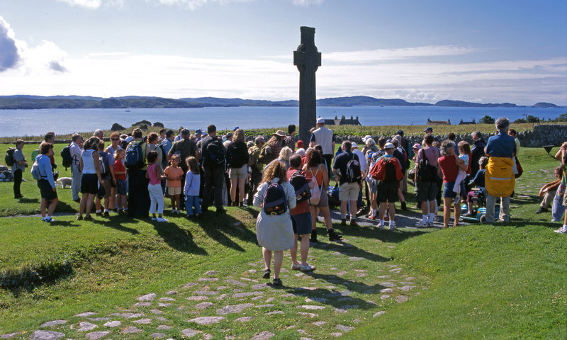 A group of visitors gather at Iona Abbey.