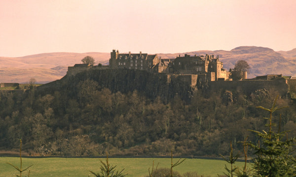 A distant view of Stirling Castle at sunset.