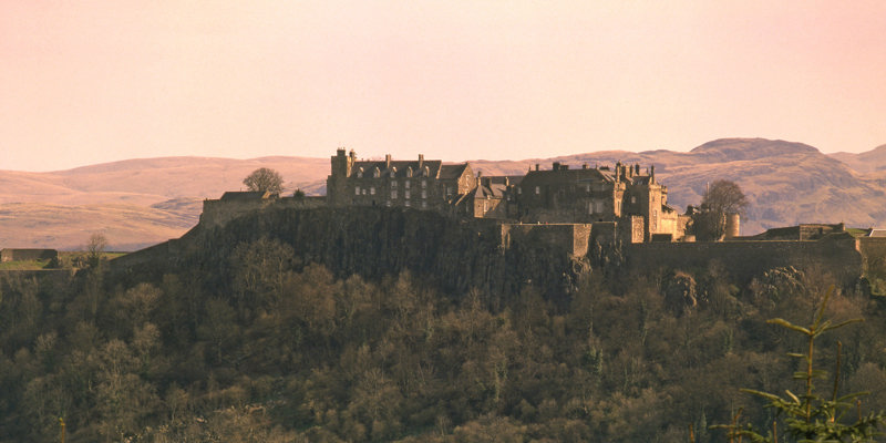 A distant view of Stirling Castle at sunset.