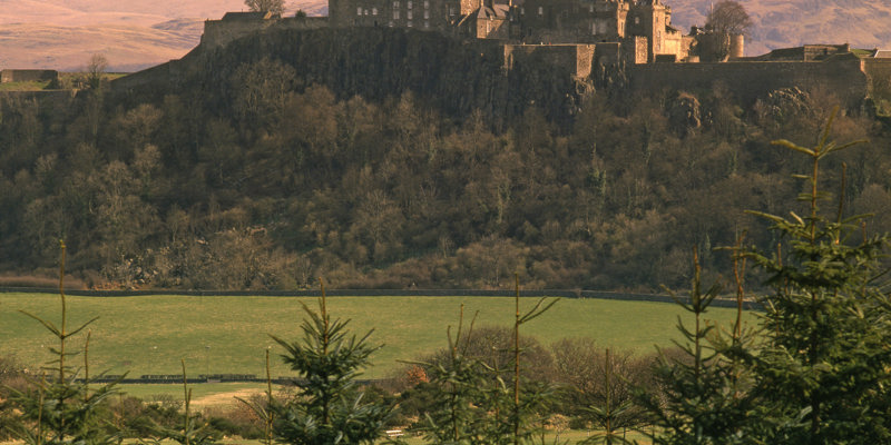 A distant view of Stirling Castle at sunset.