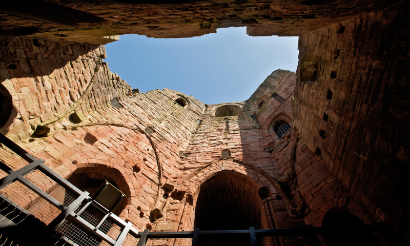 A view of the pink sandstone walls of Bothwell Castle.