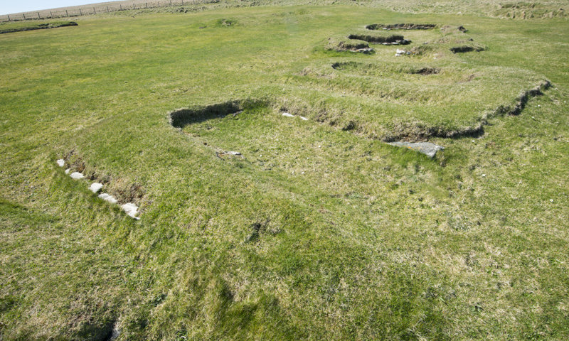 Turf-covered remains of buildings at the Brough of Birsay.