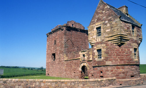  A three-storey roofless tower house, with an attached corner tower that has a playful oversailing top.