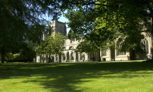Dunkeld Cathedral seen through some trees.