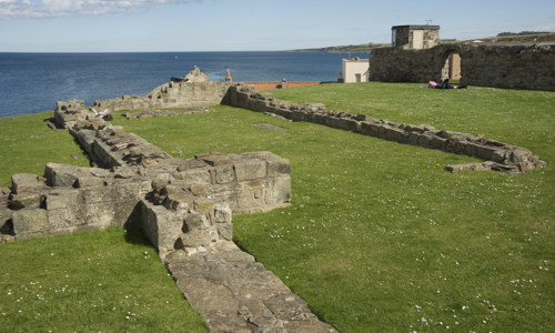 The foundations of a small cruciform church on the edge of a cliff behind St Andrews Cathedral