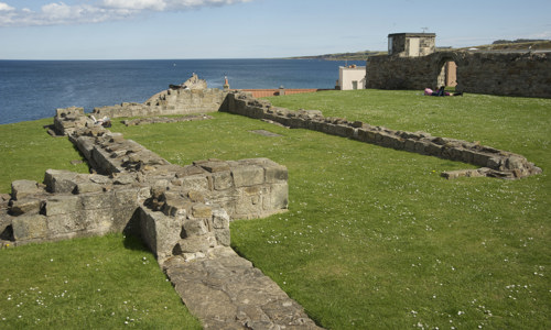 The foundations of a small cruciform church on the edge of a cliff behind St Andrews Cathedral