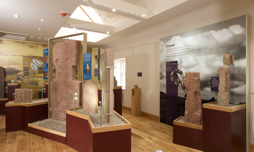 Interior of a museum with a range of pictish stones on display.
