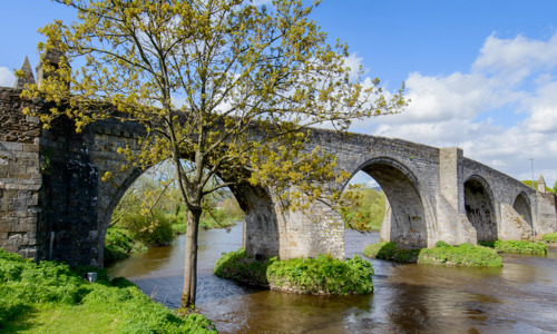 A stone bridge with several beautiful arches spanning the River Forth