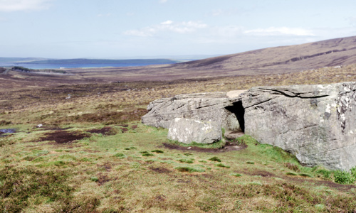 A very large block of sandstone into which a Neolithic burial chamber has been cut