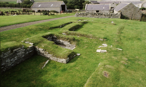 The grass covered foundations of a medieval building