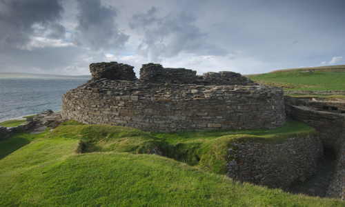 The well preserved Midhowe Broch next to a beach and the sea