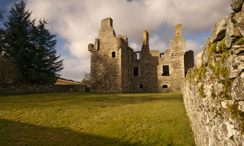 A stone wall one the right side leading to the ruins of Glenbuchat Castle