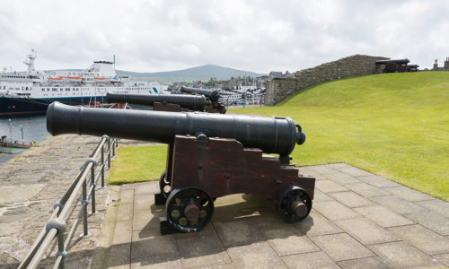 A canon pointing out to sea