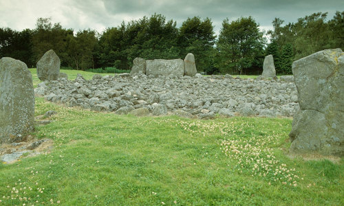 Five grey standing stones around a burial cairn