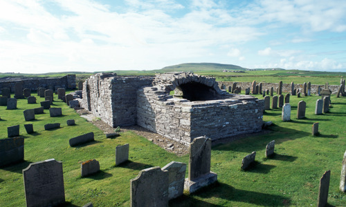 The ruined remains of Westside Church, surrounded by gravestones put up in straight lines