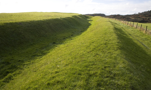 A grass-covered bank and ditch where Rispain Roman Camp used to be.