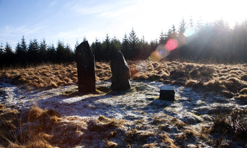 Two standing stones on a snowy clearing