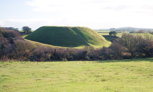 A conical mound surrounded by a ditch