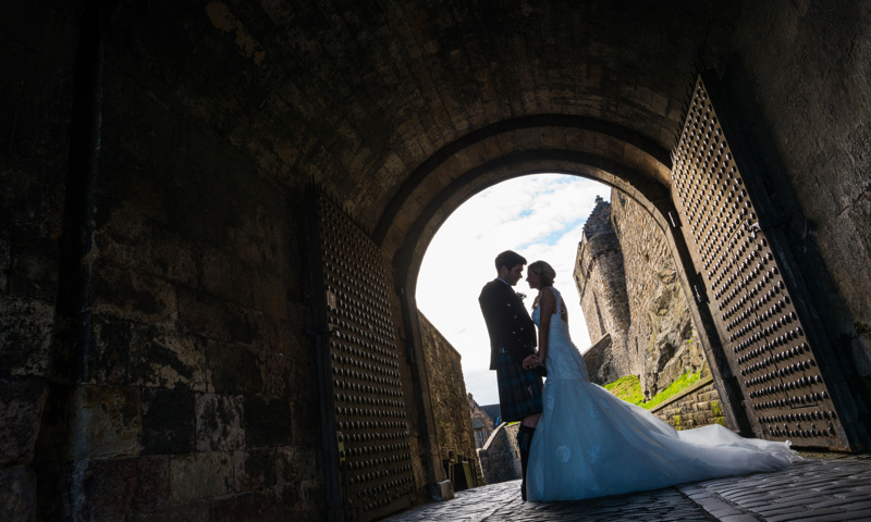 Bride and groom under archway at Edinburgh Portcullis
