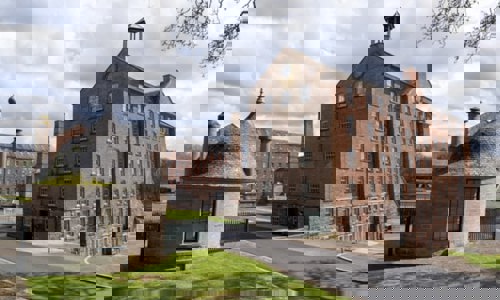 An outside view of Stanley Mills on a cloudy day 