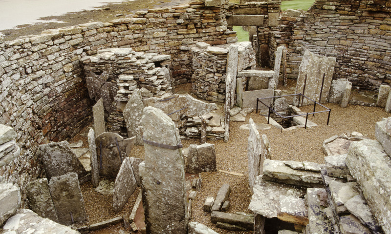 Remains of walls and upright stones within the Broch of Gurness.