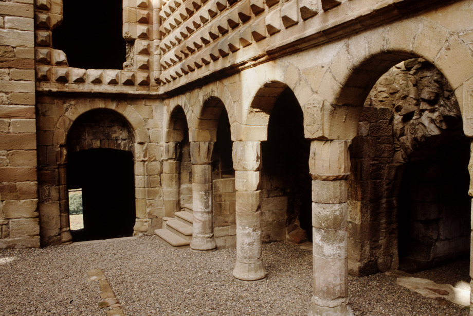 Archways beneath the great diamond facade inside Crichton Castle.