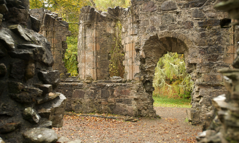 An autumnal view of a doorway and remains of a wall at Dunstaffnage Castle.