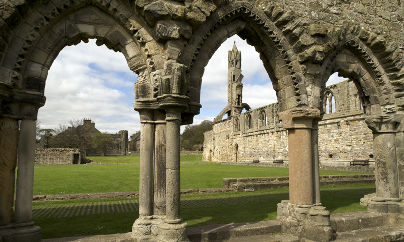 A view of the remains of St Andrews Cathedral through some arches.