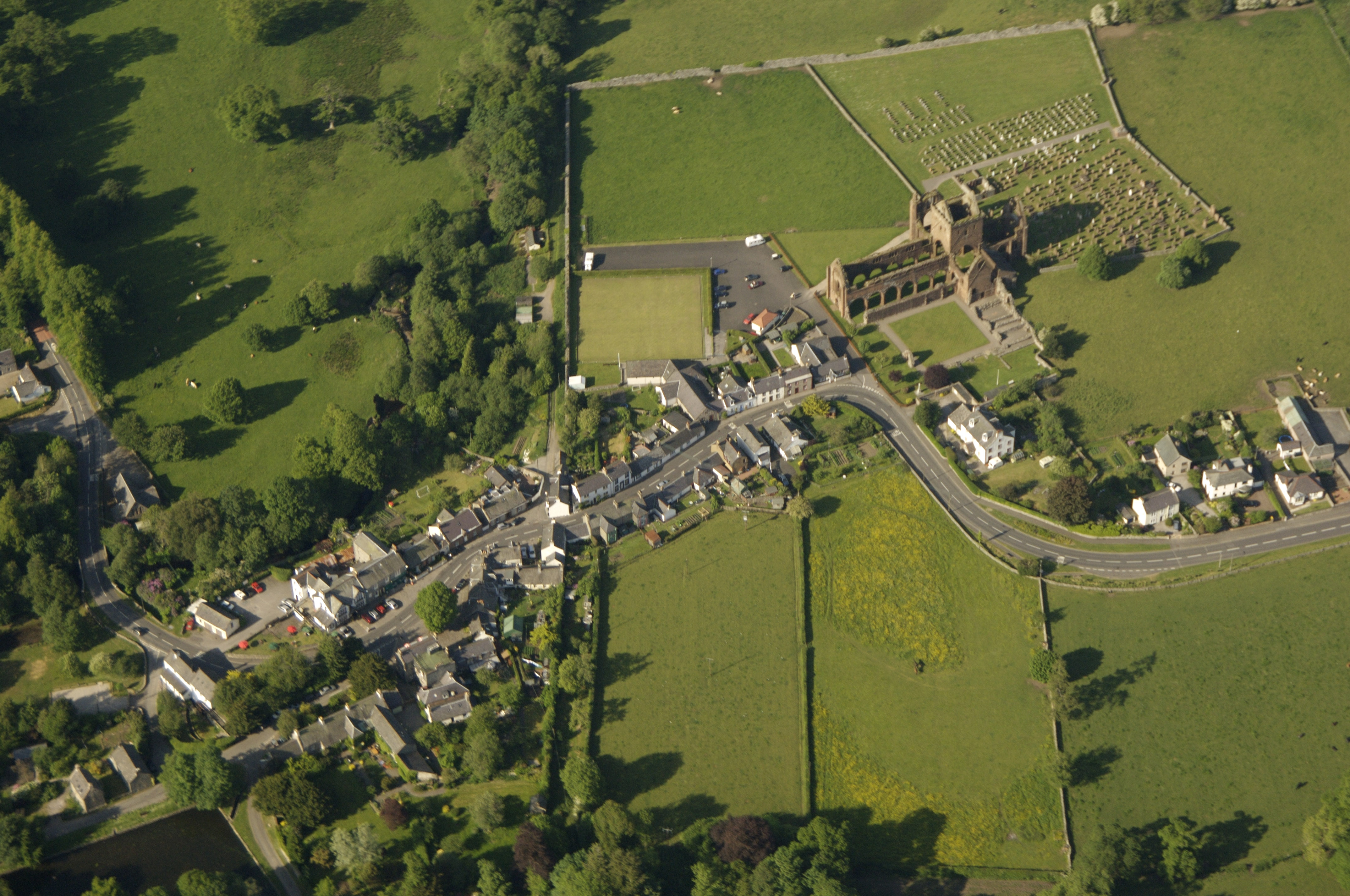 An aerial view of Sweetheart Abbey and the village of New Abbey.
