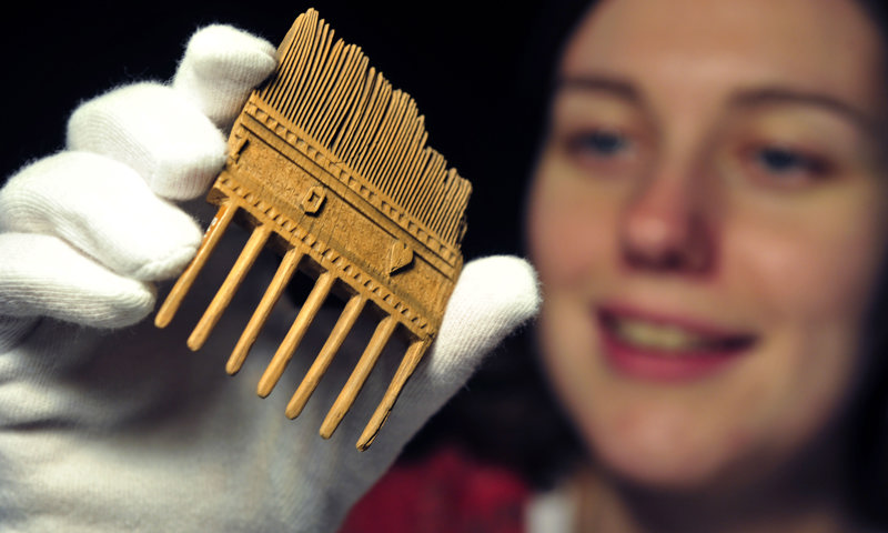 A double-sided birch wood comb from Caerlaverock Castle, dating from the 1400s. 
