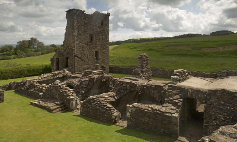 Building footings and the tower house at Crossraguel Abbey.