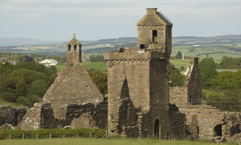 An exterior view of Crossraguel Abbey, showing the gatehouse and other buildings.