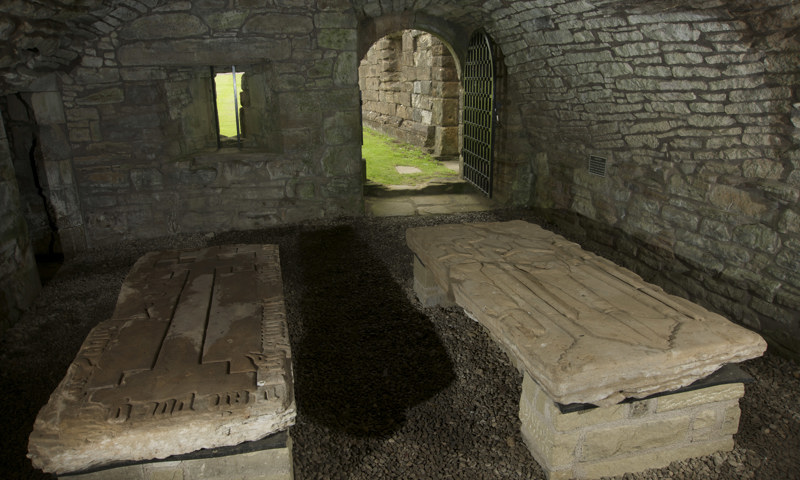 A view of tombstones in the undercroft of Crossraguel Abbey.