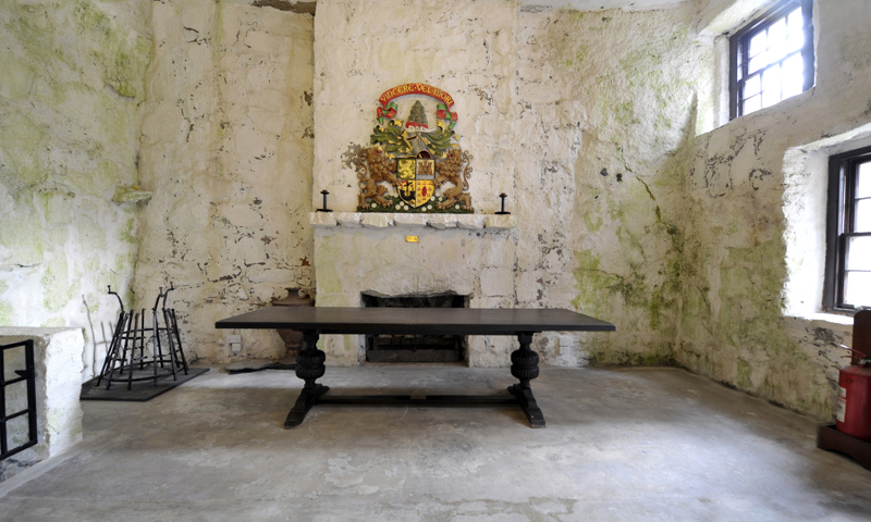 A coat of arms above the fireplace in the great hall at Kisimul Castle.