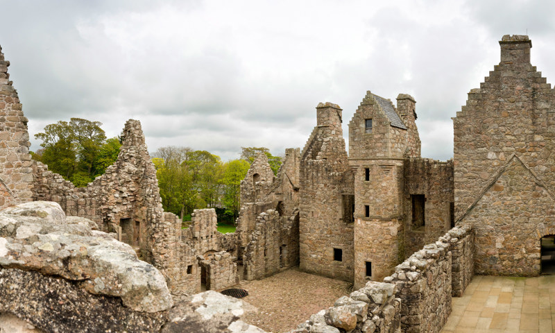 A view inside the castle walls at Tolquhon Castle, including the courtyard and towers.