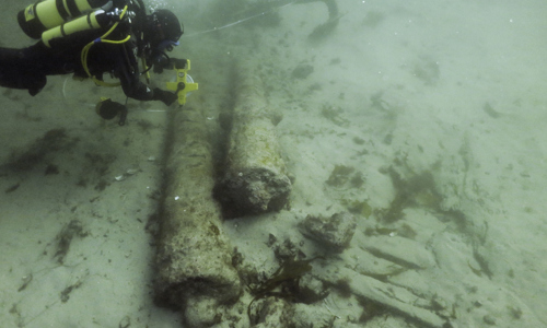 diver investigating guns and hull structure on Drumbeg historic wreck (courtesy Wessex Archaeology)