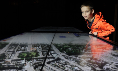 A young visitor inspects an aerial photo of Edinburgh as part of the Tale of Two Cities exhibit at Edinburgh Castle.
