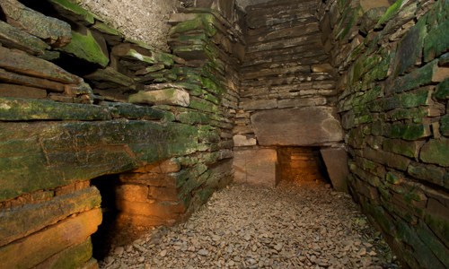 The inside of a narrow but tall chambered cairn